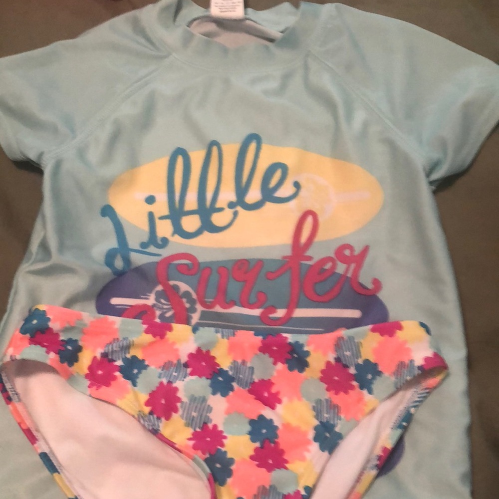 Awesome two piece swim set with short sleeve top and  Bikini bottom size 7/8